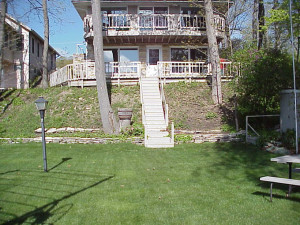This "before" picture shows the challenges of the steep slope and existing trees on site. It also shows the intimidating wood steps the owners wanted to eliminate.