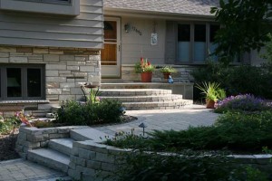 The front entry features arced entry steps that lead up to the main porch. Strategically placed lannon stone retaining walls create a generous landing for grad transitions. Lannon park steps are incorporated into the retaining walls to continue the entry transition. Special attention was given to ensure that there were never more than four steps between landings to make the entry more user friendly.
