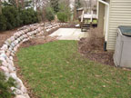 This backyard lacked the charm this cape cod home deserved. This was remedied by a design that called for removal of existing concrete steps and patio. In their place, Holland stone pavers and lannon park steps were installed to add the needed charm. The flagstone pathway not only provides access to this cozy space but also allows the owner to enjoy the waterfall and pond along the way.
