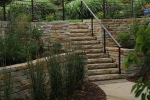 Lake Access – The Chilton stone steps with handrail are seamlessly integrated into the retaining walls creating a safe and pleasant transition from the upper patio down to the waterfront.